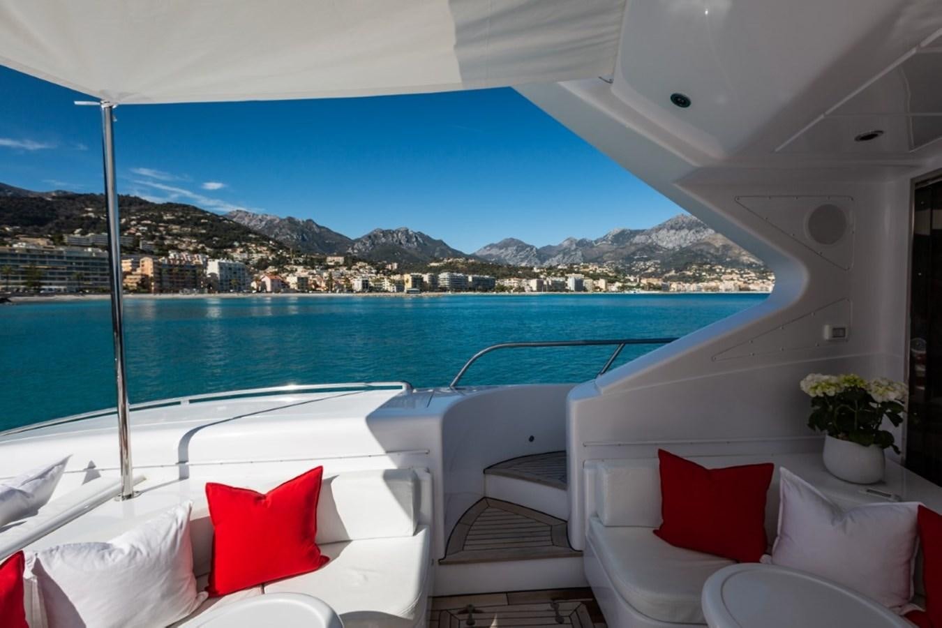 a room with a view of a city and water aboard BELISA Yacht for Sale
