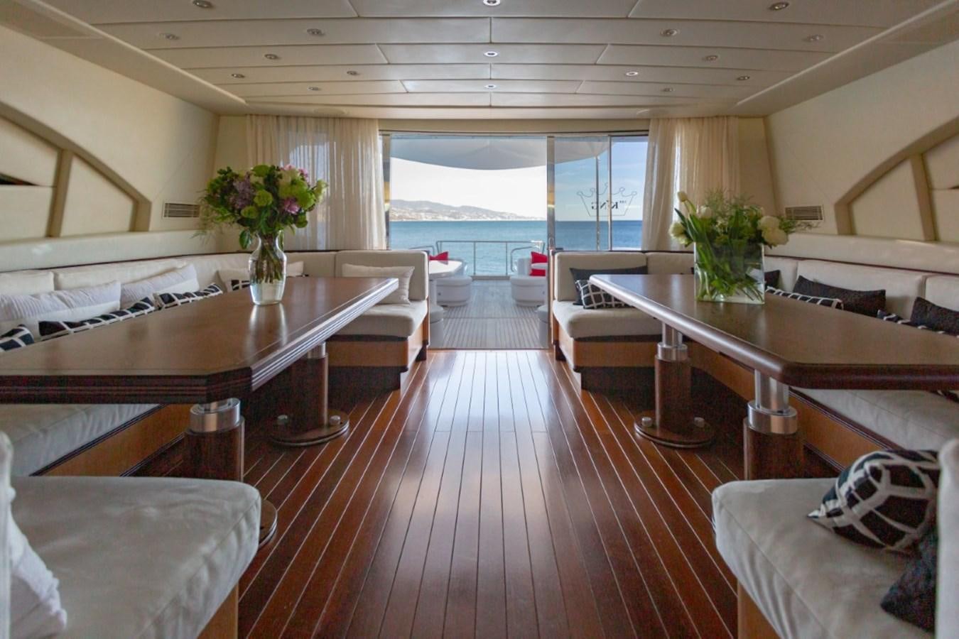 a large room with a table and chairs aboard BELISA Yacht for Sale