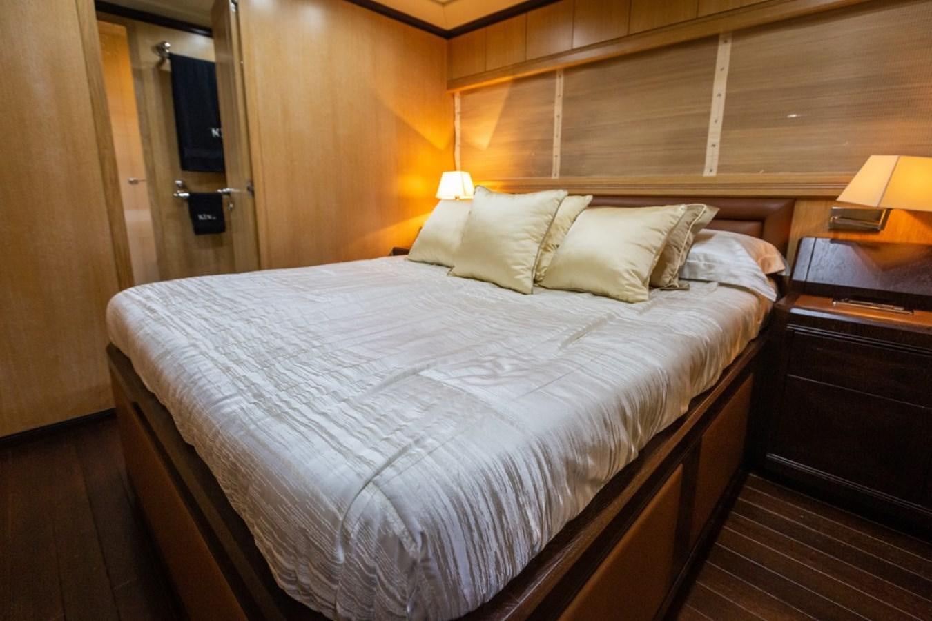 a bed with a white sheet aboard BELISA Yacht for Sale
