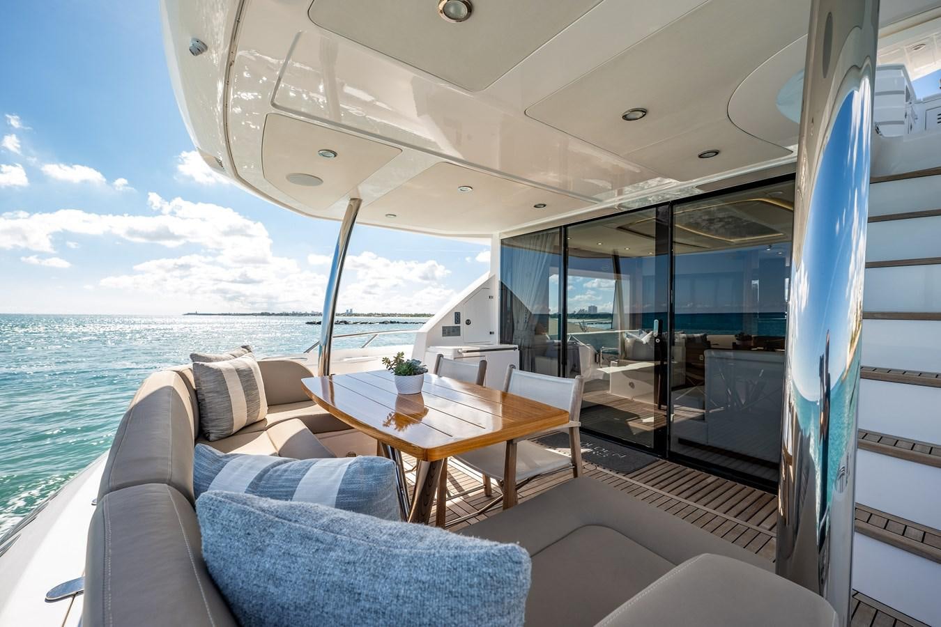 a boat with a table and chairs aboard GOLDEN OURS Yacht for Sale