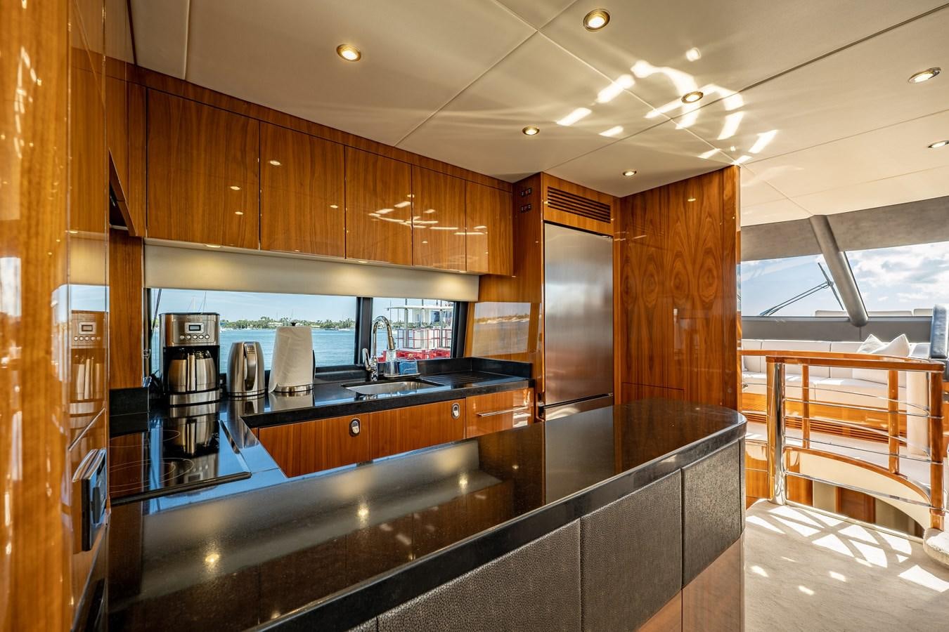 a kitchen with wooden cabinets aboard GOLDEN OURS Yacht for Sale