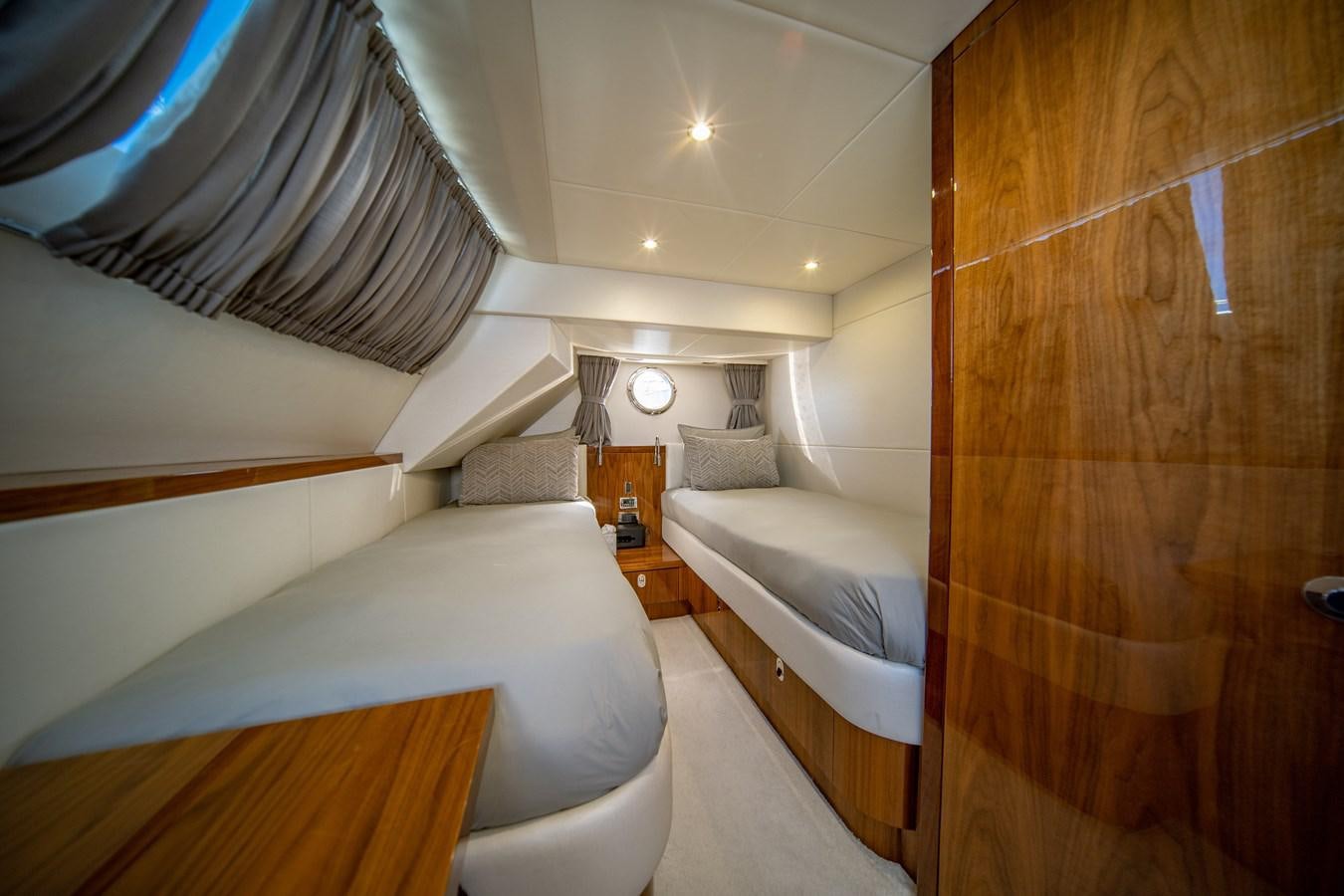 a room with a bed and a wood door aboard GOLDEN OURS Yacht for Sale