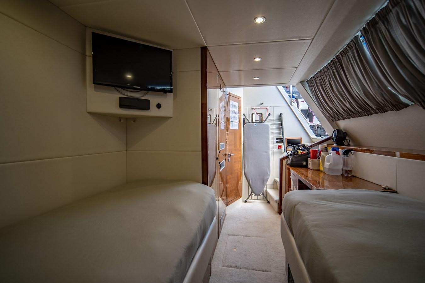 a room with a bed and a television aboard GOLDEN OURS Yacht for Sale