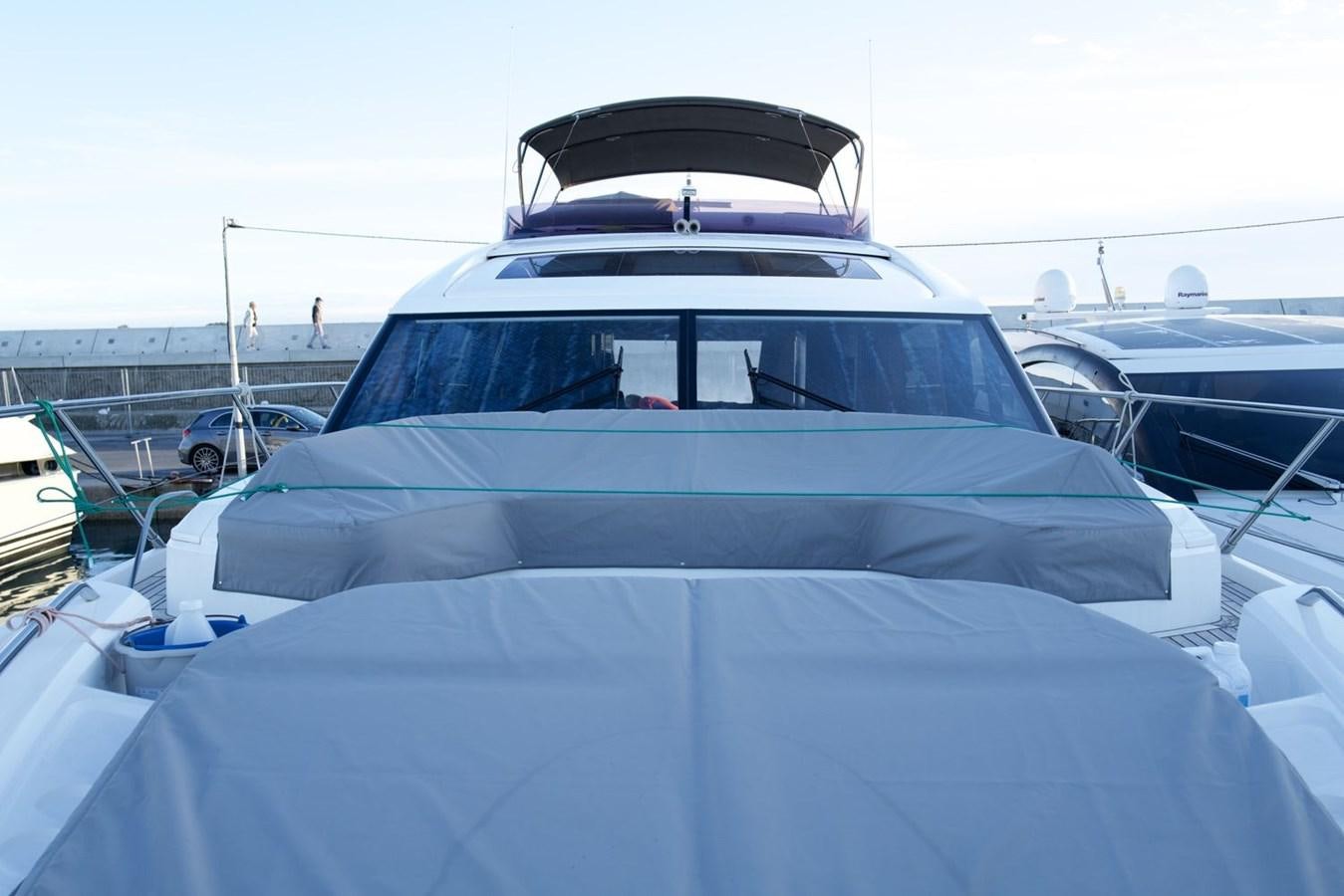 a white car with a blue roof aboard PRINCESS S65 Yacht for Sale