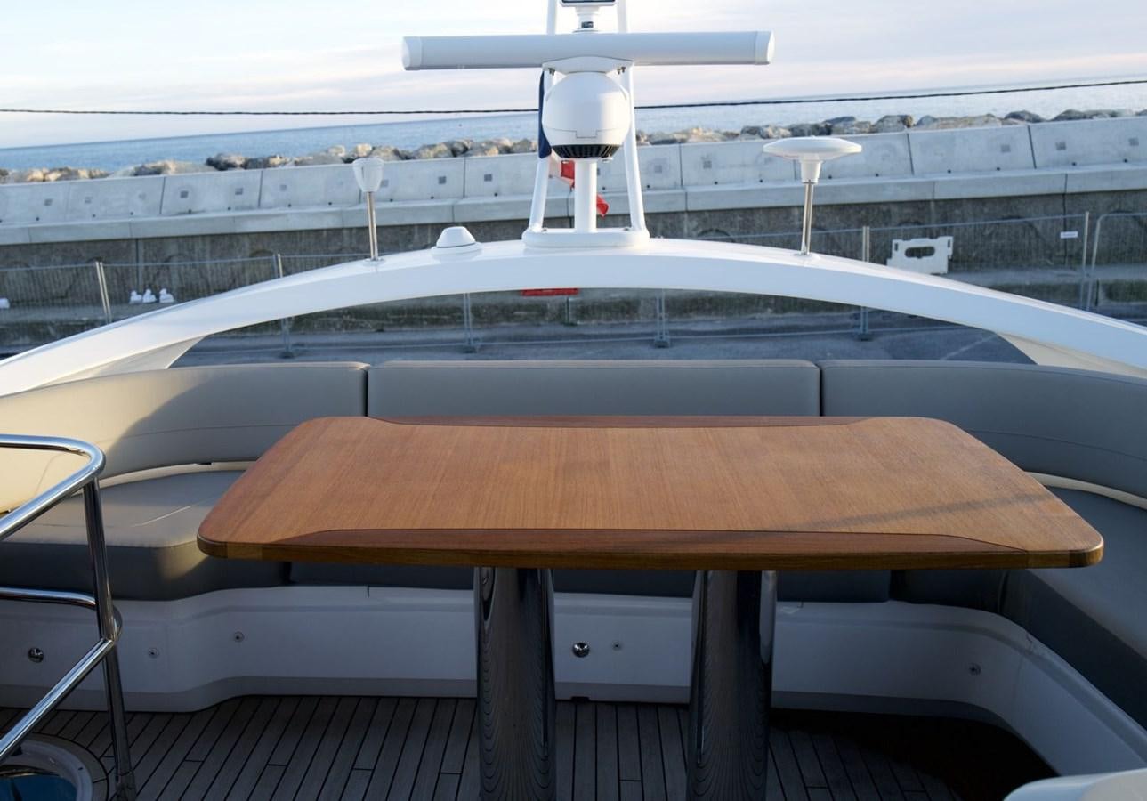 a wooden table on a deck aboard PRINCESS S65 Yacht for Sale