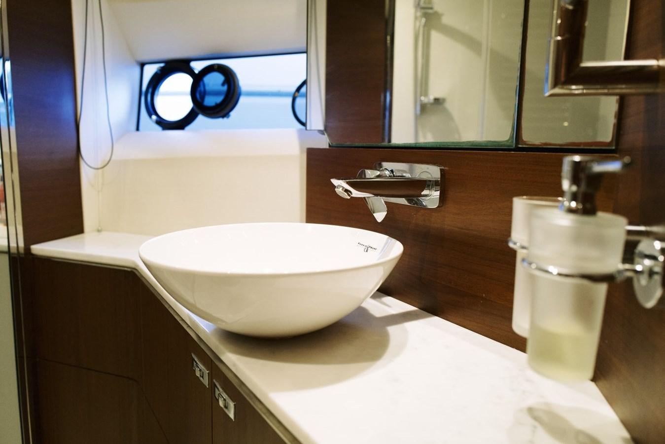 a bathroom with a sink and a mirror aboard PRINCESS S65 Yacht for Sale