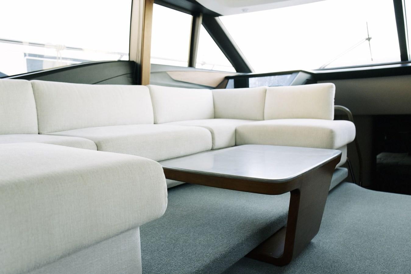 a couch and a table in a room aboard PRINCESS S65 Yacht for Sale