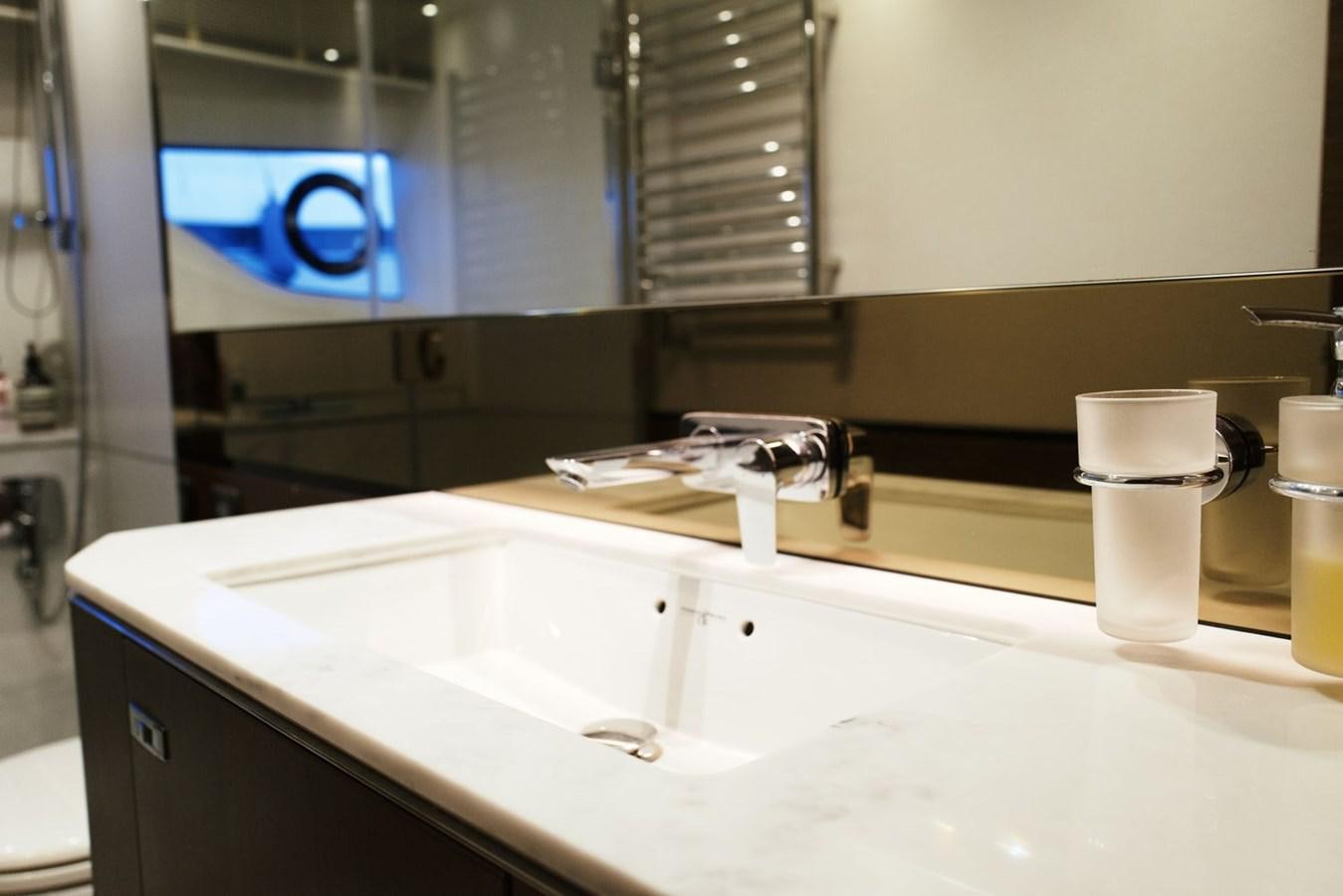 a bathroom with a large mirror aboard PRINCESS S65 Yacht for Sale