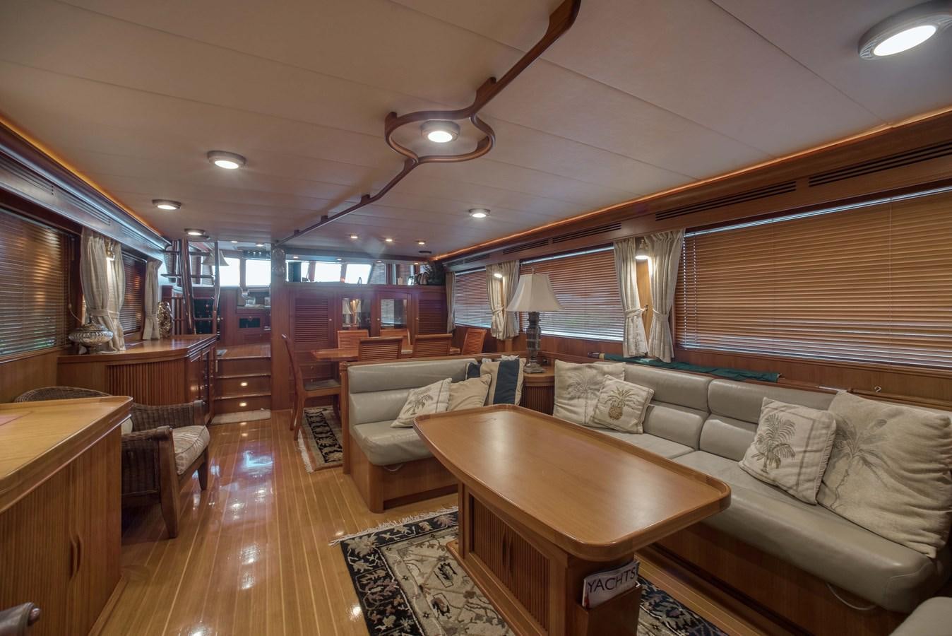 a living room with a table and couches aboard BLUE ROSY V Yacht for Sale