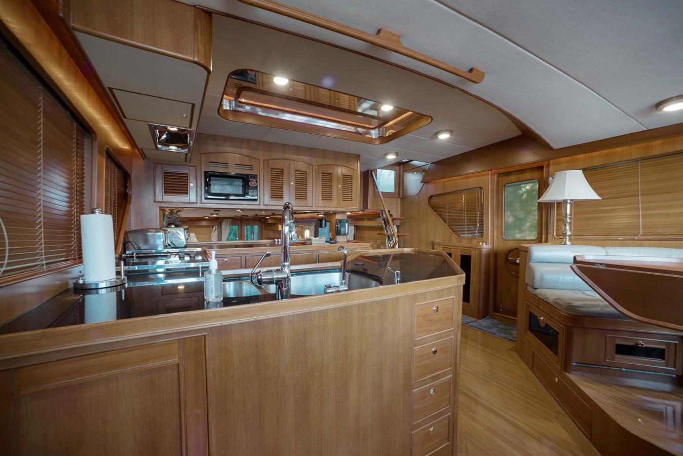 a kitchen with wooden cabinets aboard BLUE ROSY V Yacht for Sale