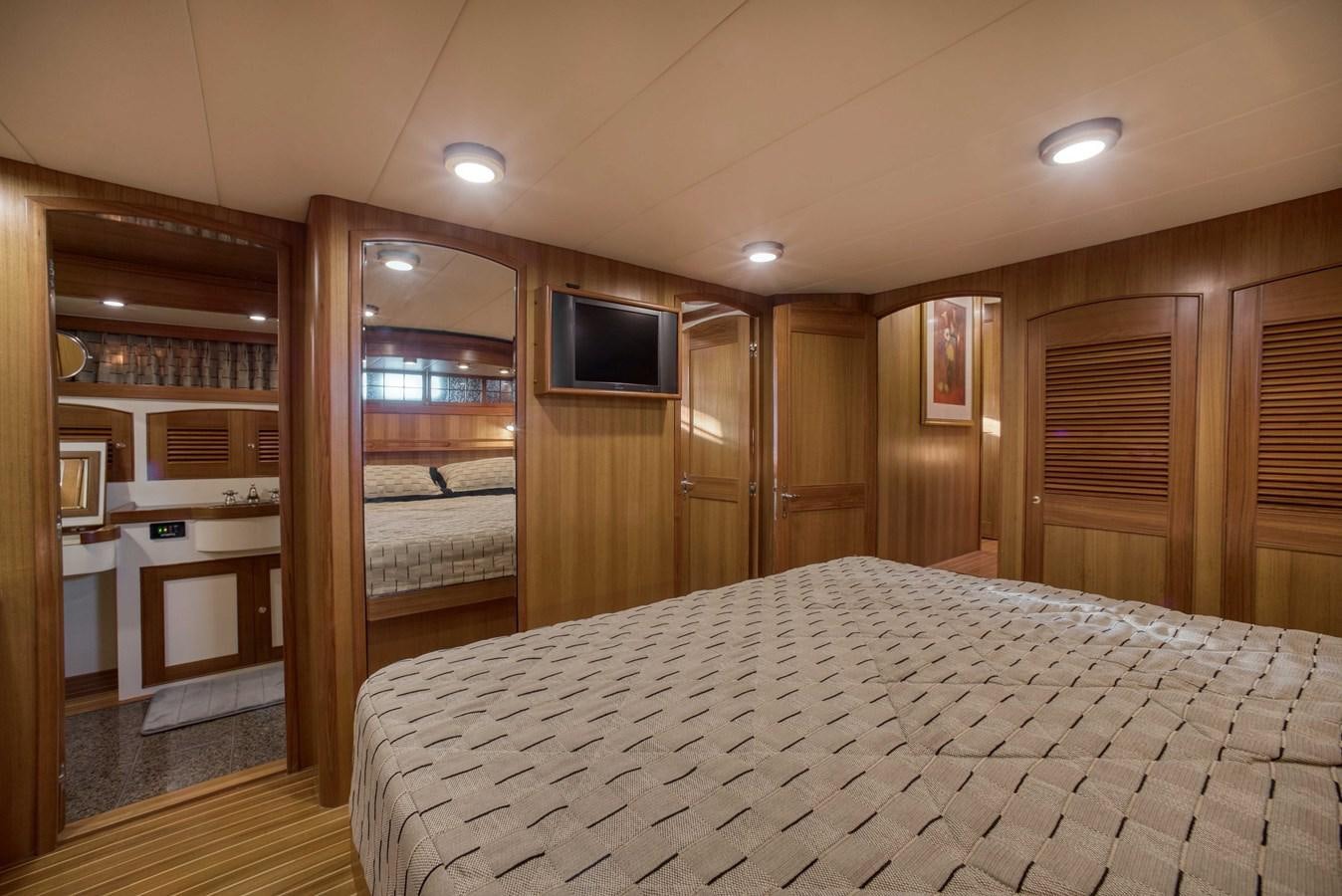 a bedroom with a large bed aboard BLUE ROSY V Yacht for Sale