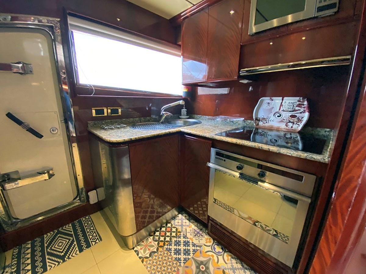 a kitchen with wooden cabinets aboard SPEED 5 Yacht for Sale