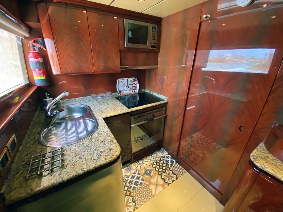 a kitchen with wooden cabinets aboard SPEED 5 Yacht for Sale