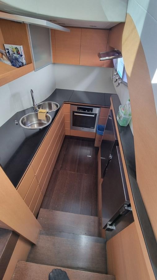 a kitchen with wooden cabinets aboard GUSS 97 Yacht for Sale