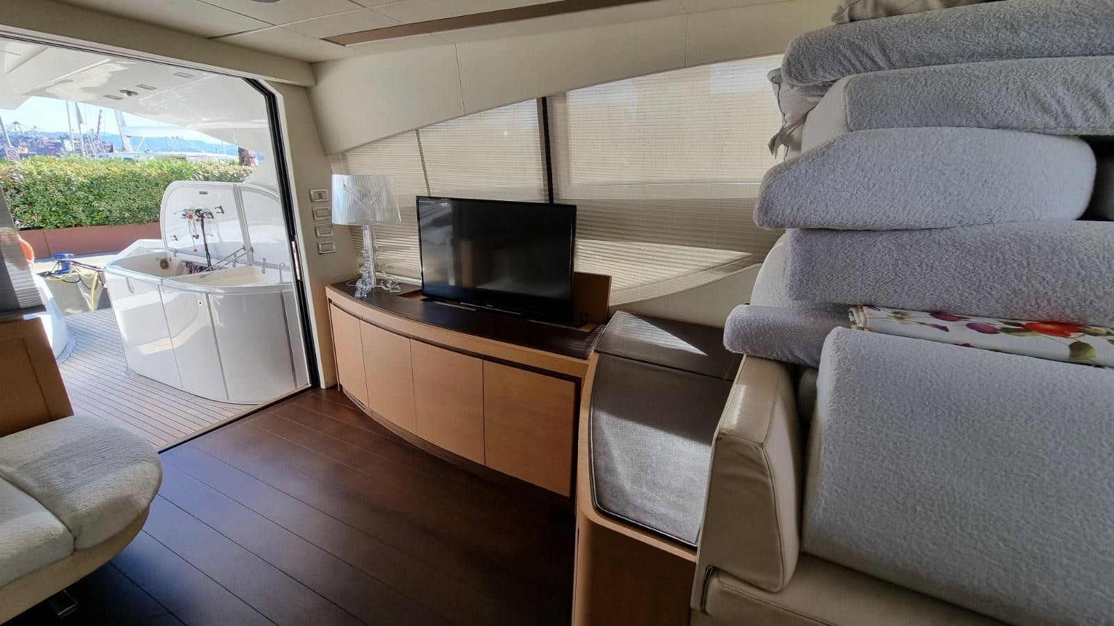 a living room with a couch and a television aboard GUSS 97 Yacht for Sale