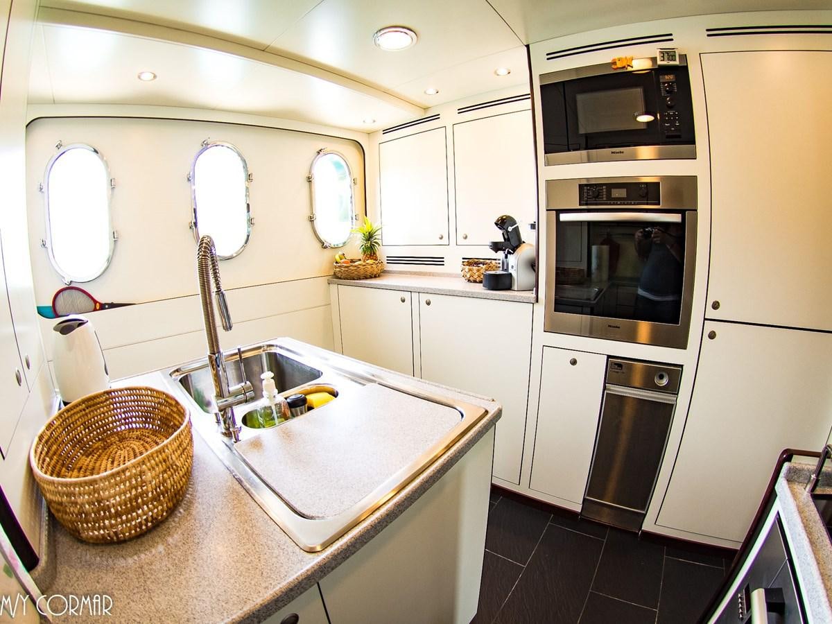 a kitchen with a sink and microwave aboard cormar Yacht for Sale