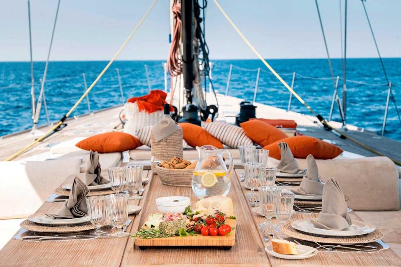 a table with food and drinks on it aboard LOGICA Yacht for Sale