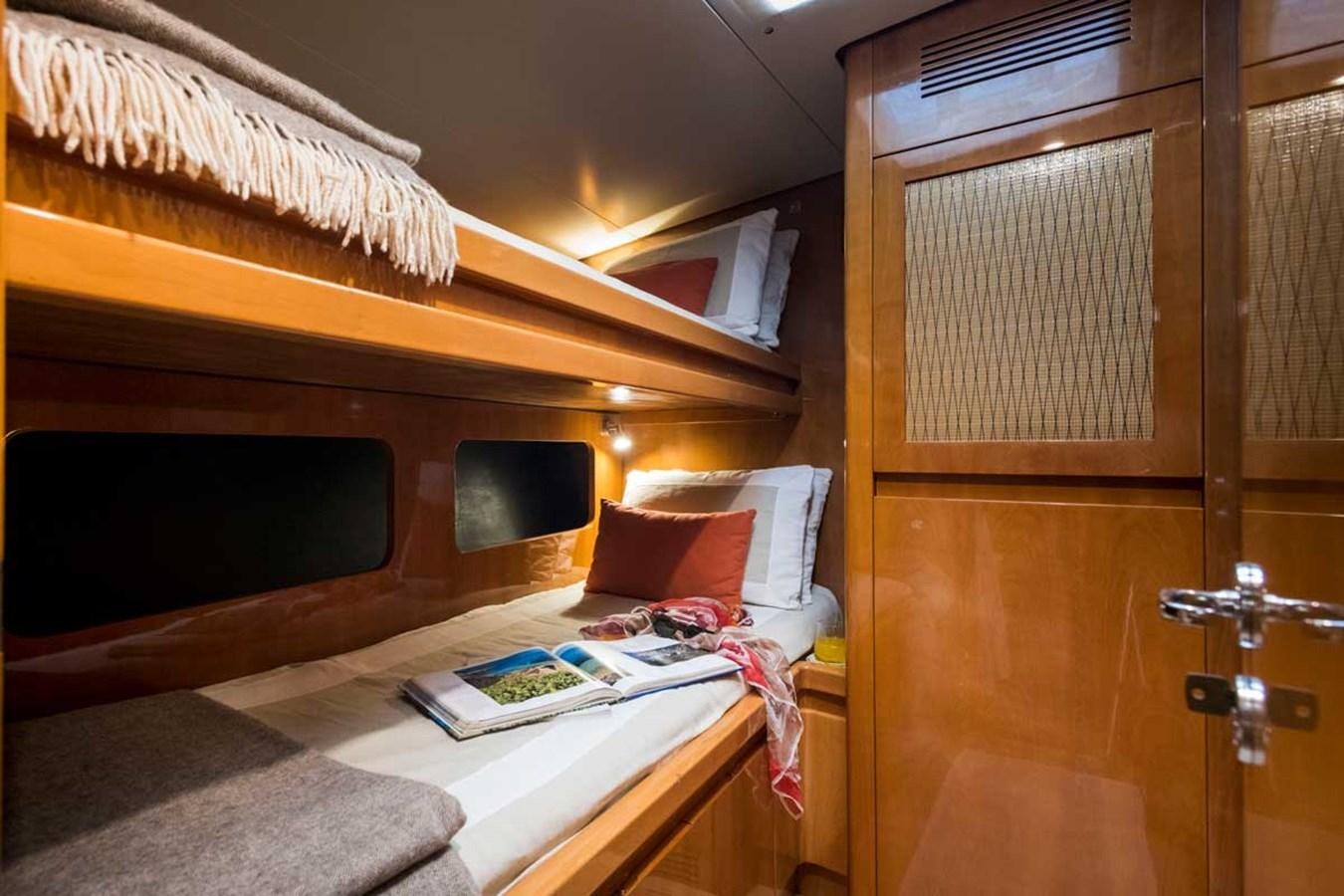 a bed with a desk and a chair aboard LOGICA Yacht for Sale