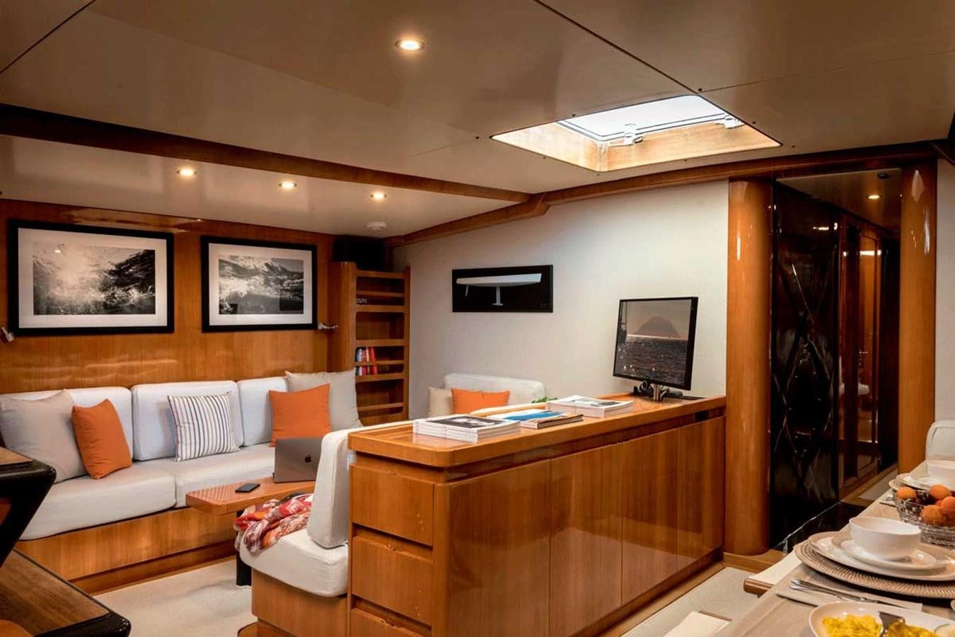 a living room with a couch and a television aboard LOGICA Yacht for Sale