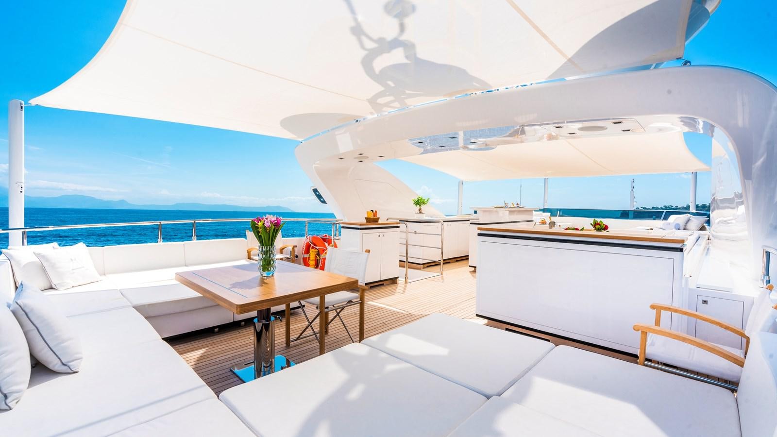 a room with a table and chairs aboard AAA Yacht for Sale