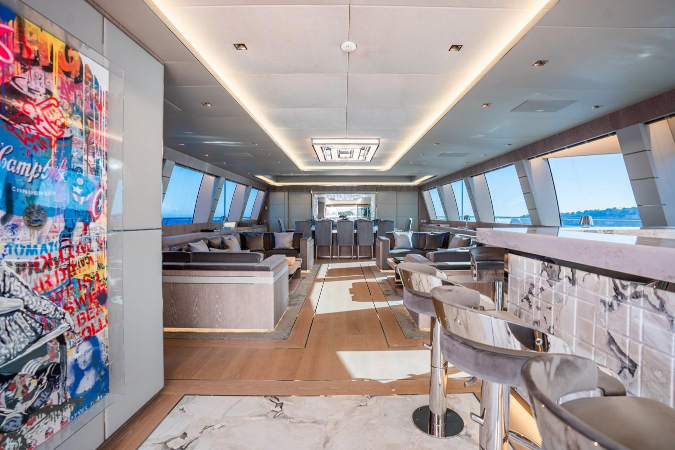 inside of a building with chairs and tables aboard AAA Yacht for Sale