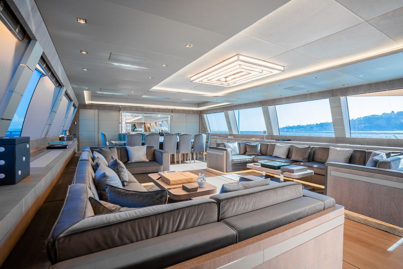 a living room with a large sofa aboard AAA Yacht for Sale