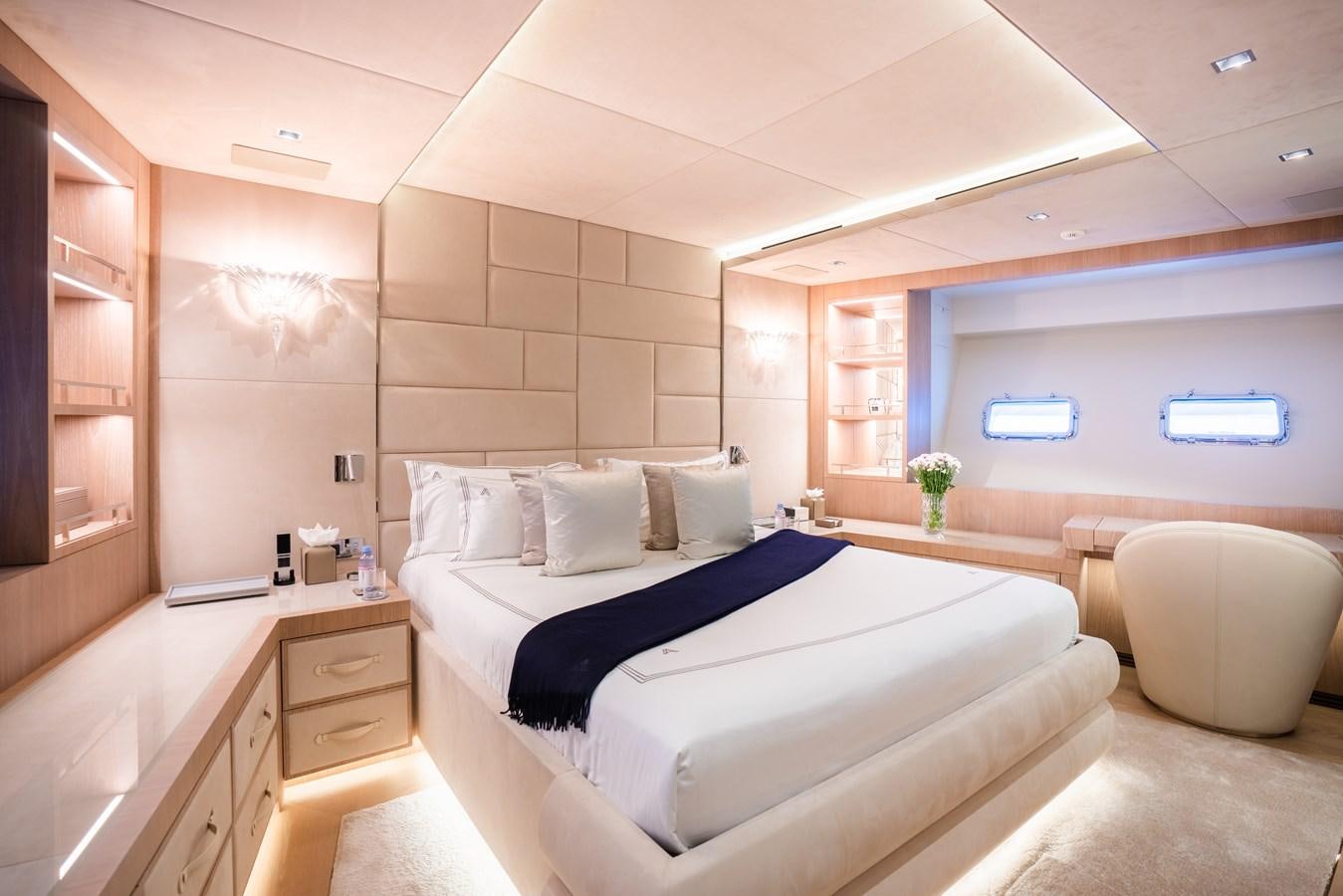 a room with a bed and a chair aboard AAA Yacht for Sale