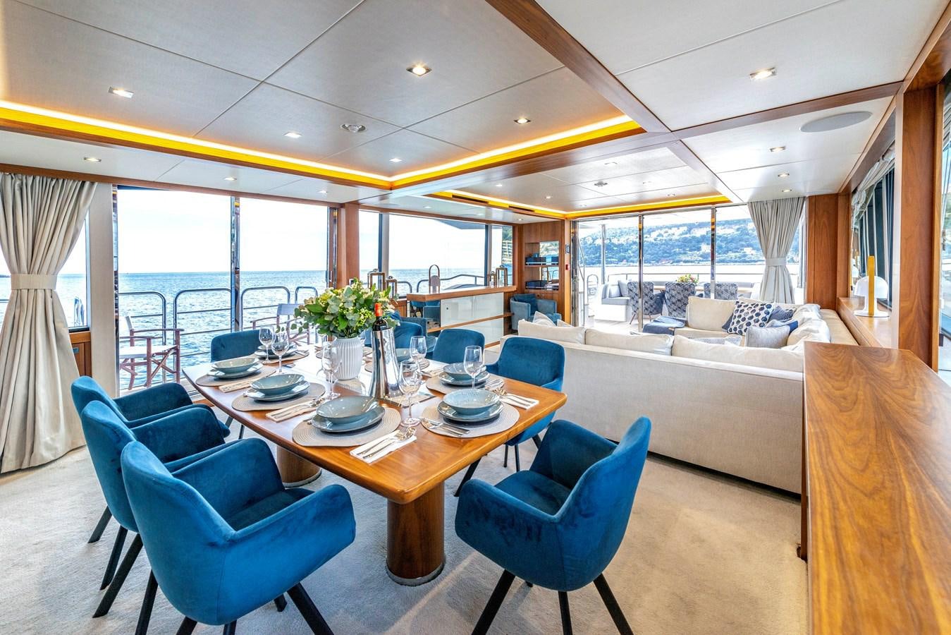 a living room with a large table and chairs aboard TAKE OFF Yacht for Sale