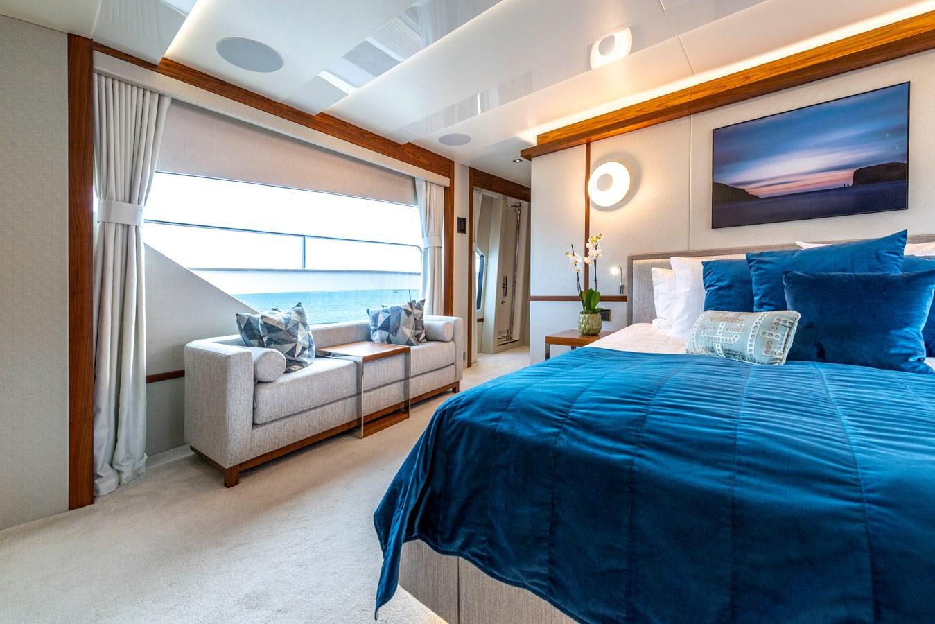 a bedroom with a bed and a couch aboard TAKE OFF Yacht for Sale