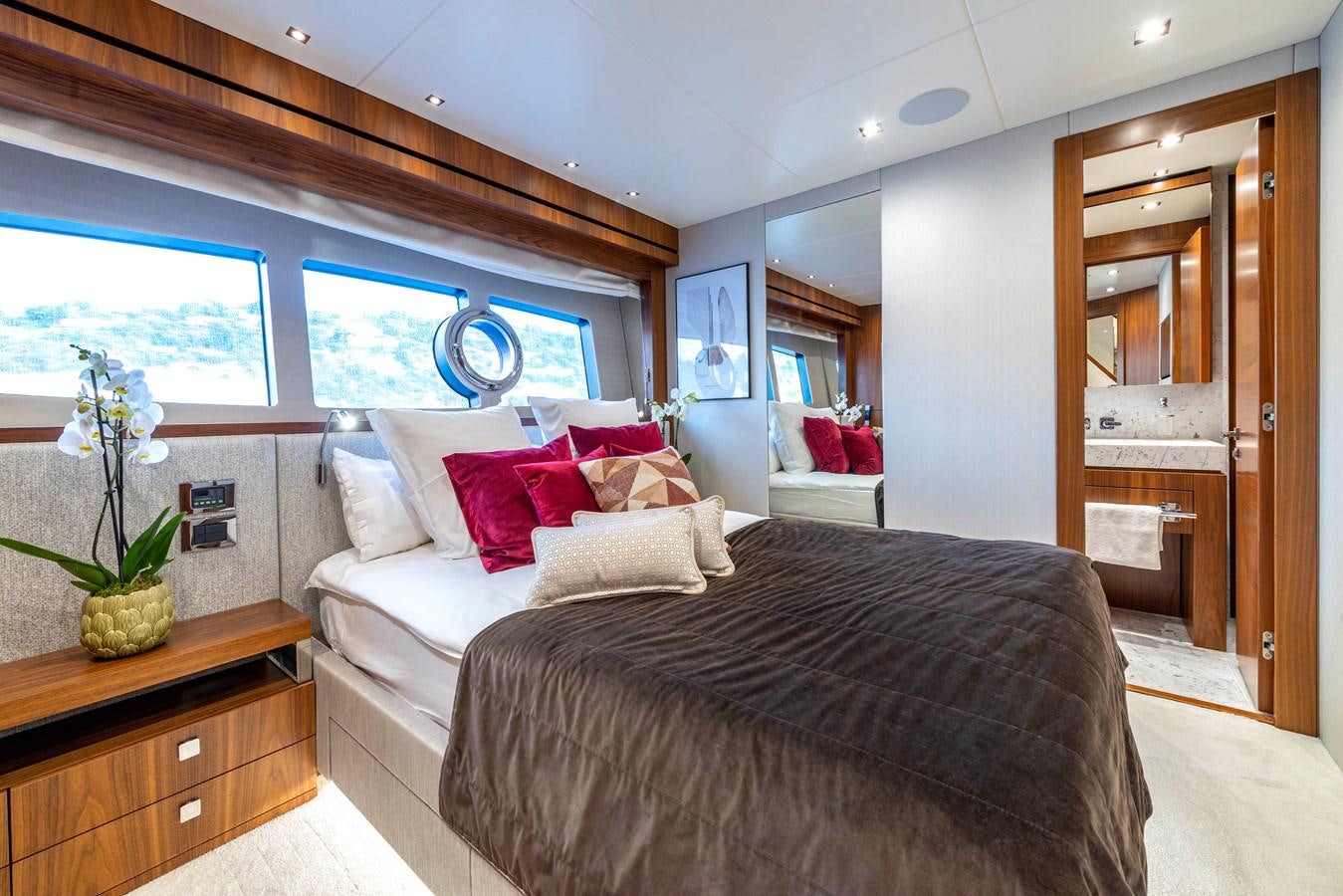 a bedroom with a bed and a plant aboard TAKE OFF Yacht for Sale