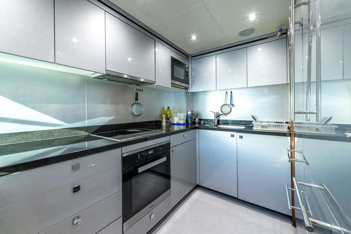 a kitchen with white cabinets aboard TAKE OFF Yacht for Sale