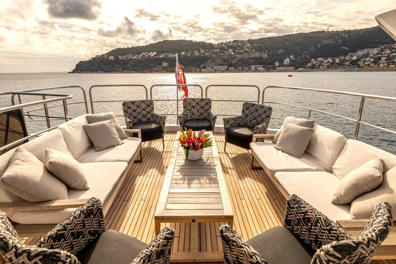 a deck with chairs and a body of water in the background aboard TAKE OFF Yacht for Sale