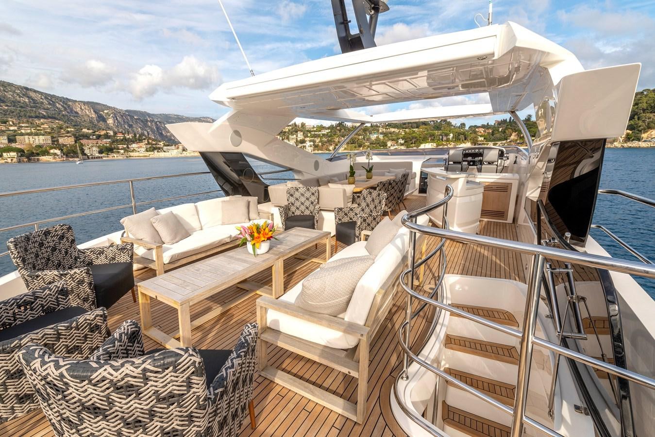 a deck with a table and chairs on it aboard TAKE OFF Yacht for Sale
