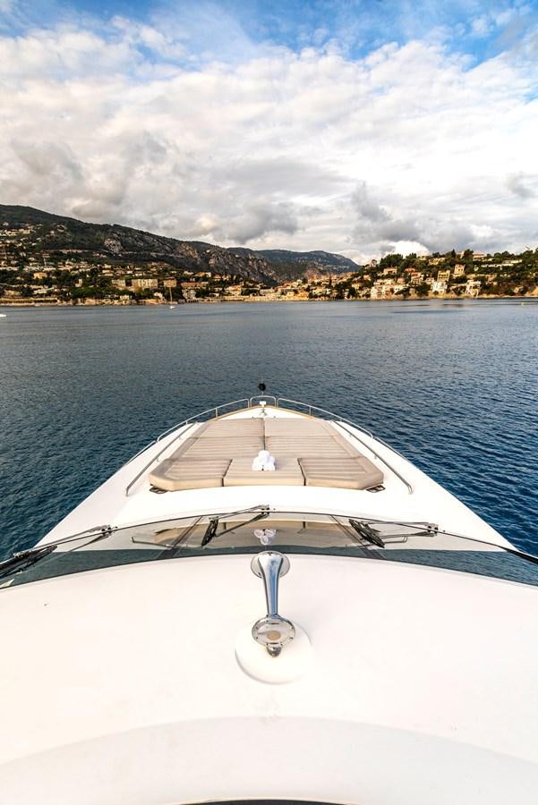 a white boat on the water aboard TAKE OFF Yacht for Sale