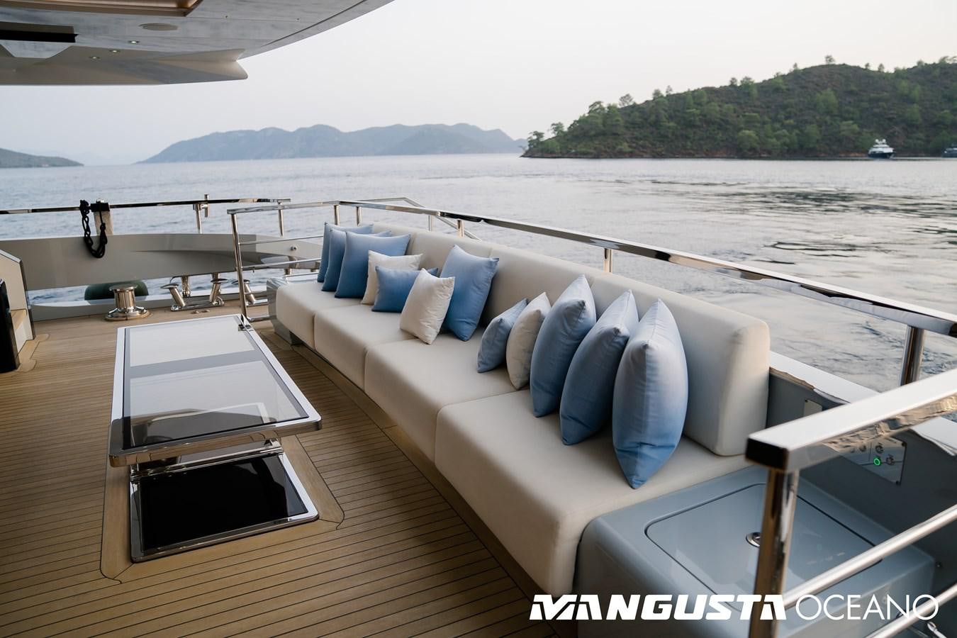 a couch on a deck overlooking a body of water aboard SANCTUARY Yacht for Sale