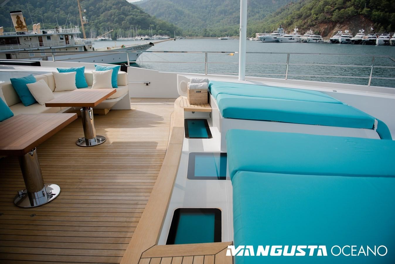 a pool with a deck and chairs aboard SANCTUARY Yacht for Sale