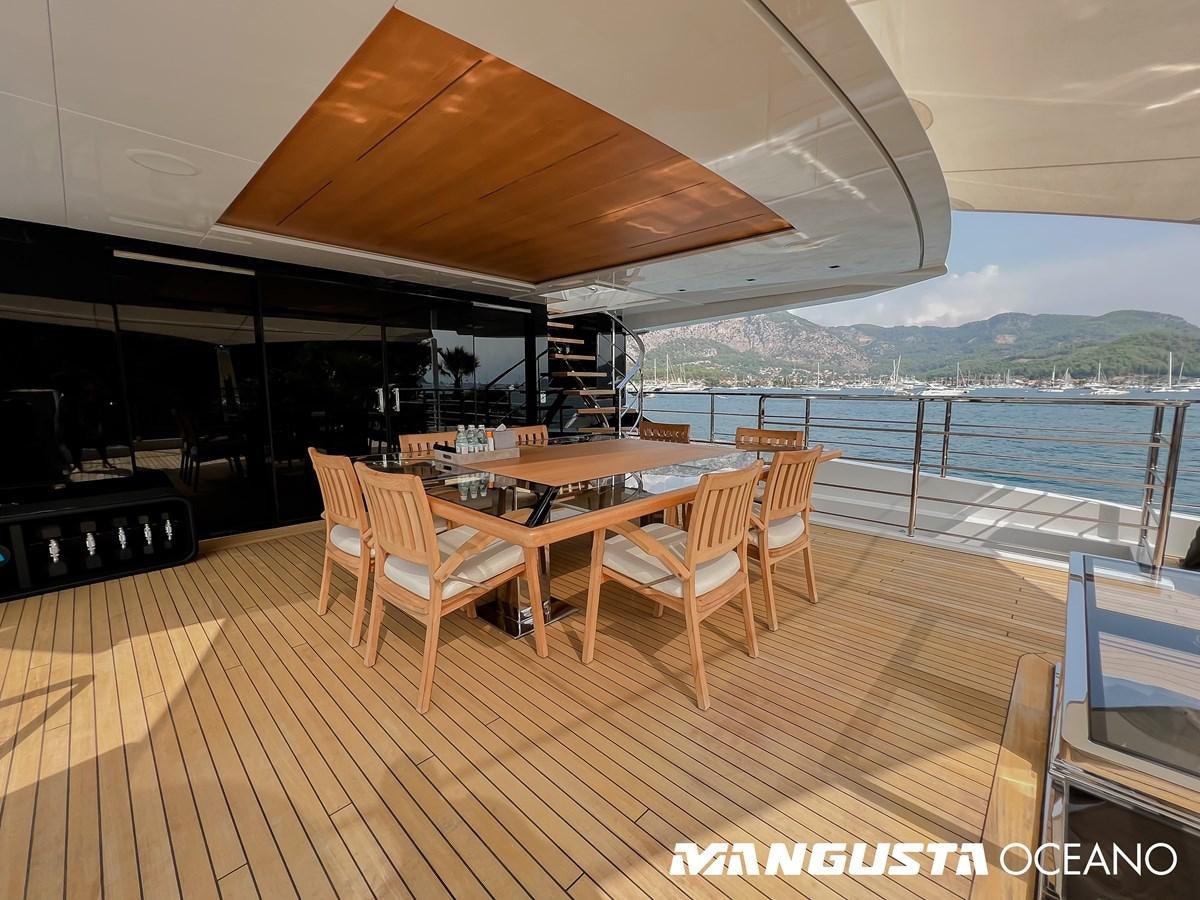 a deck with a table and chairs aboard SANCTUARY Yacht for Sale