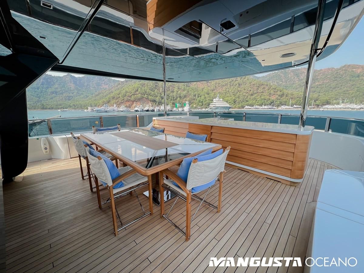 a deck with chairs and a table aboard SANCTUARY Yacht for Sale