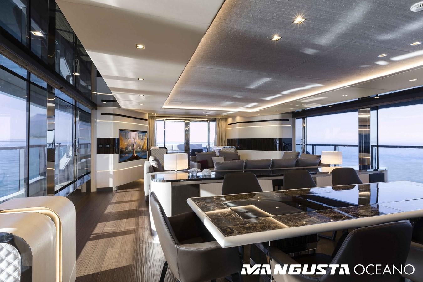 a room with a table chairs and a large window aboard SANCTUARY Yacht for Sale