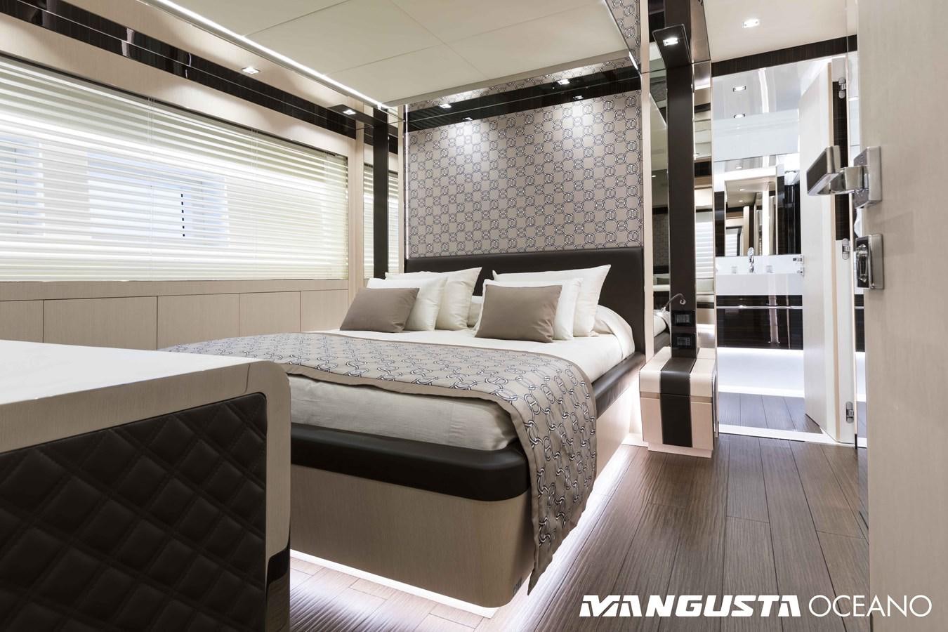a room with a bed and a mirror aboard SANCTUARY Yacht for Sale