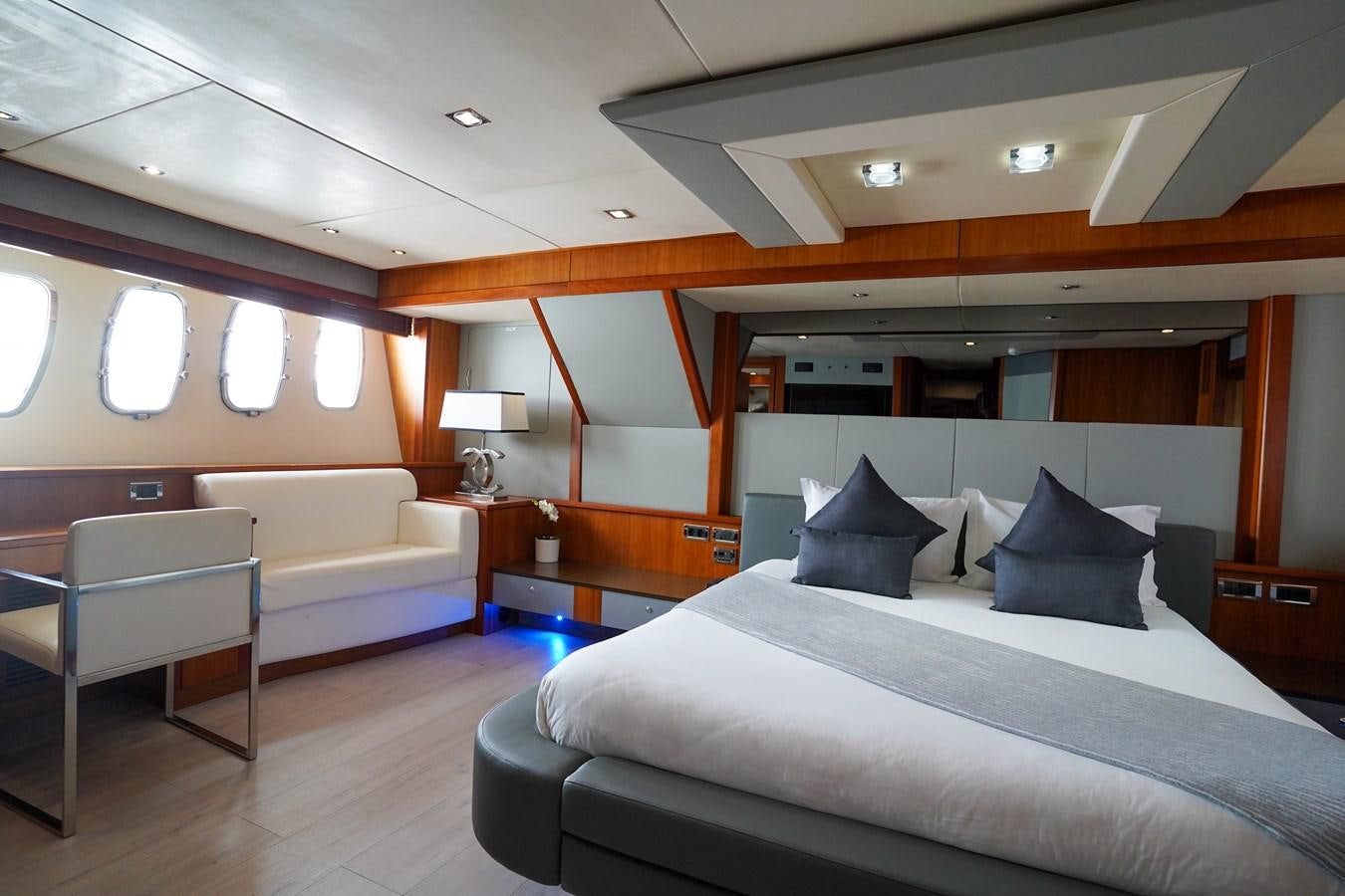 a room with a bed and a chair aboard LIJOR Yacht for Sale