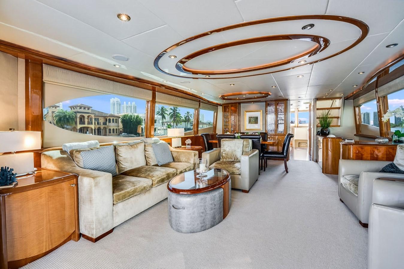a living room with a large chandelier aboard CHIP Yacht for Sale