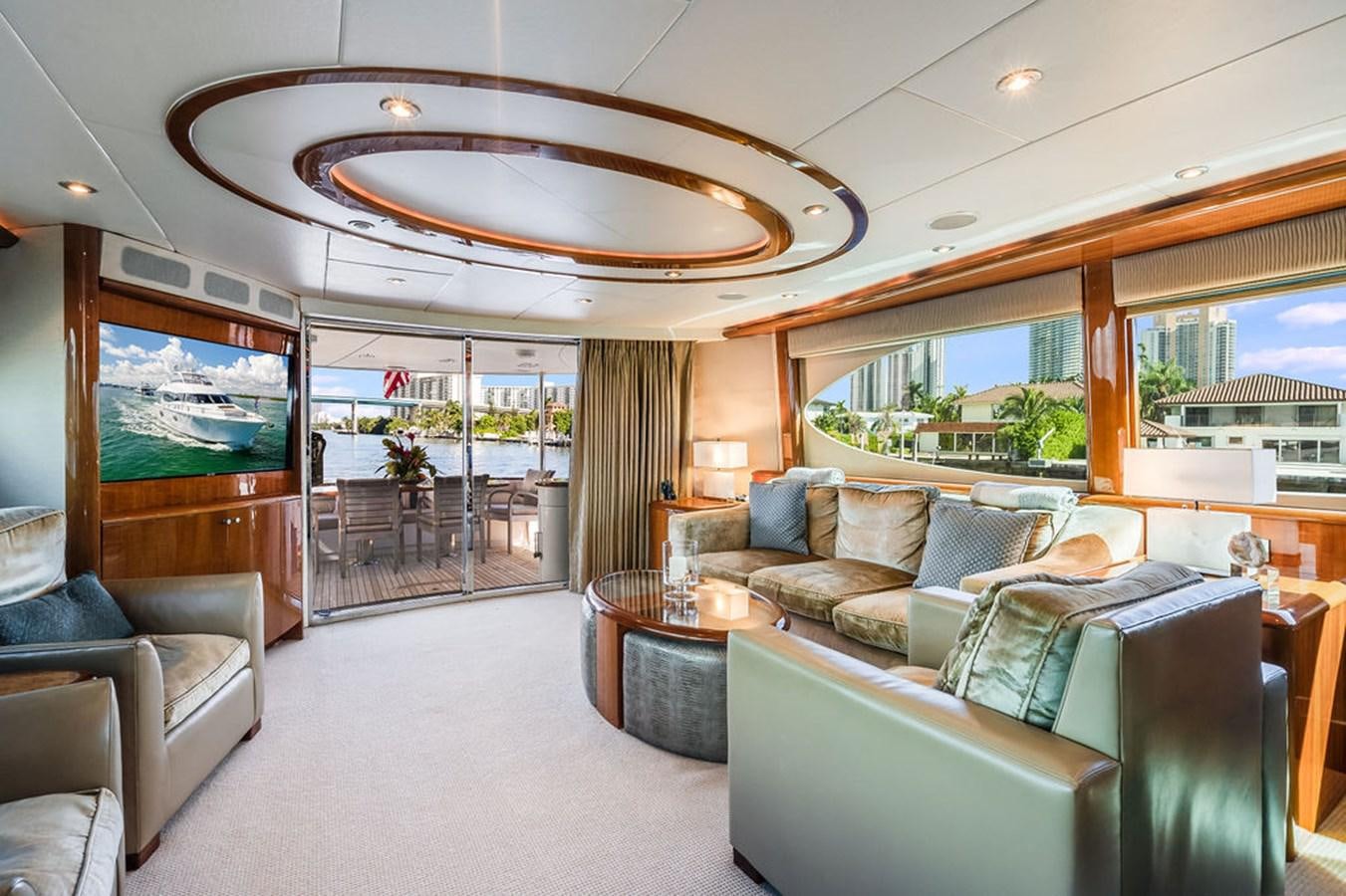 a living room with a large chandelier aboard CHIP Yacht for Sale