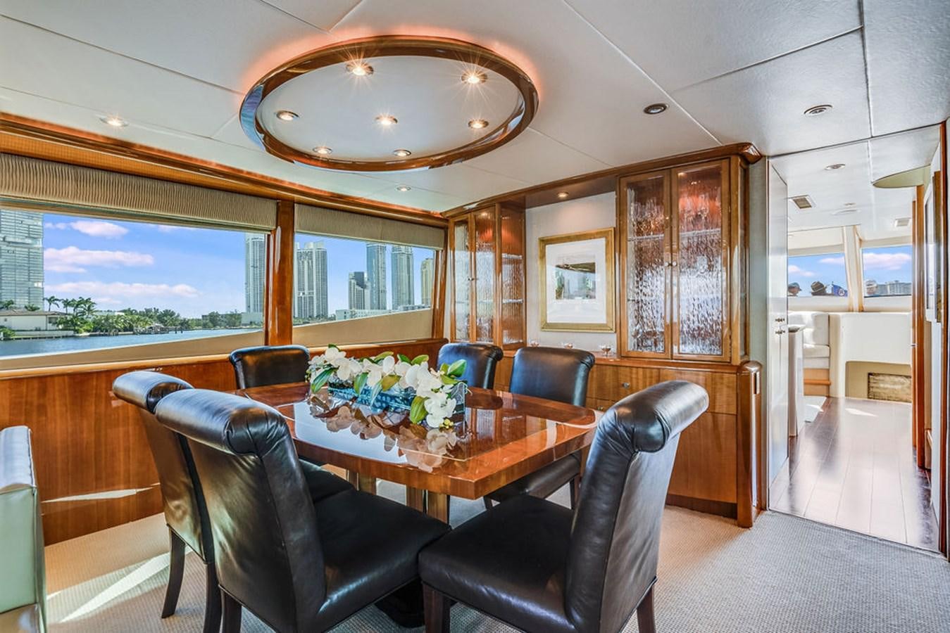 a room with a table and chairs aboard CHIP Yacht for Sale