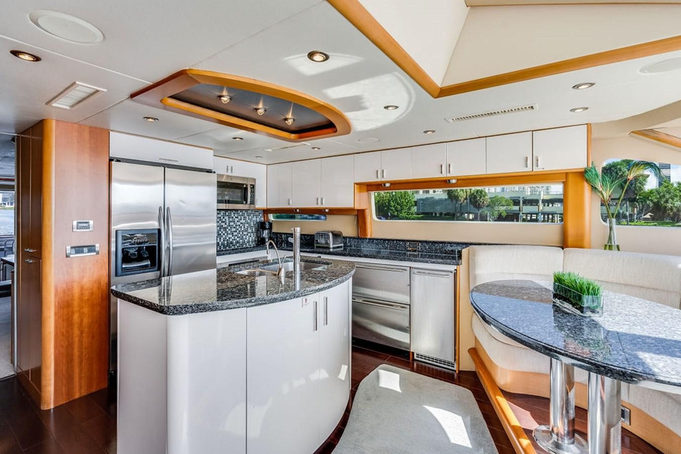 a kitchen with a table and a refrigerator aboard CHIP Yacht for Sale