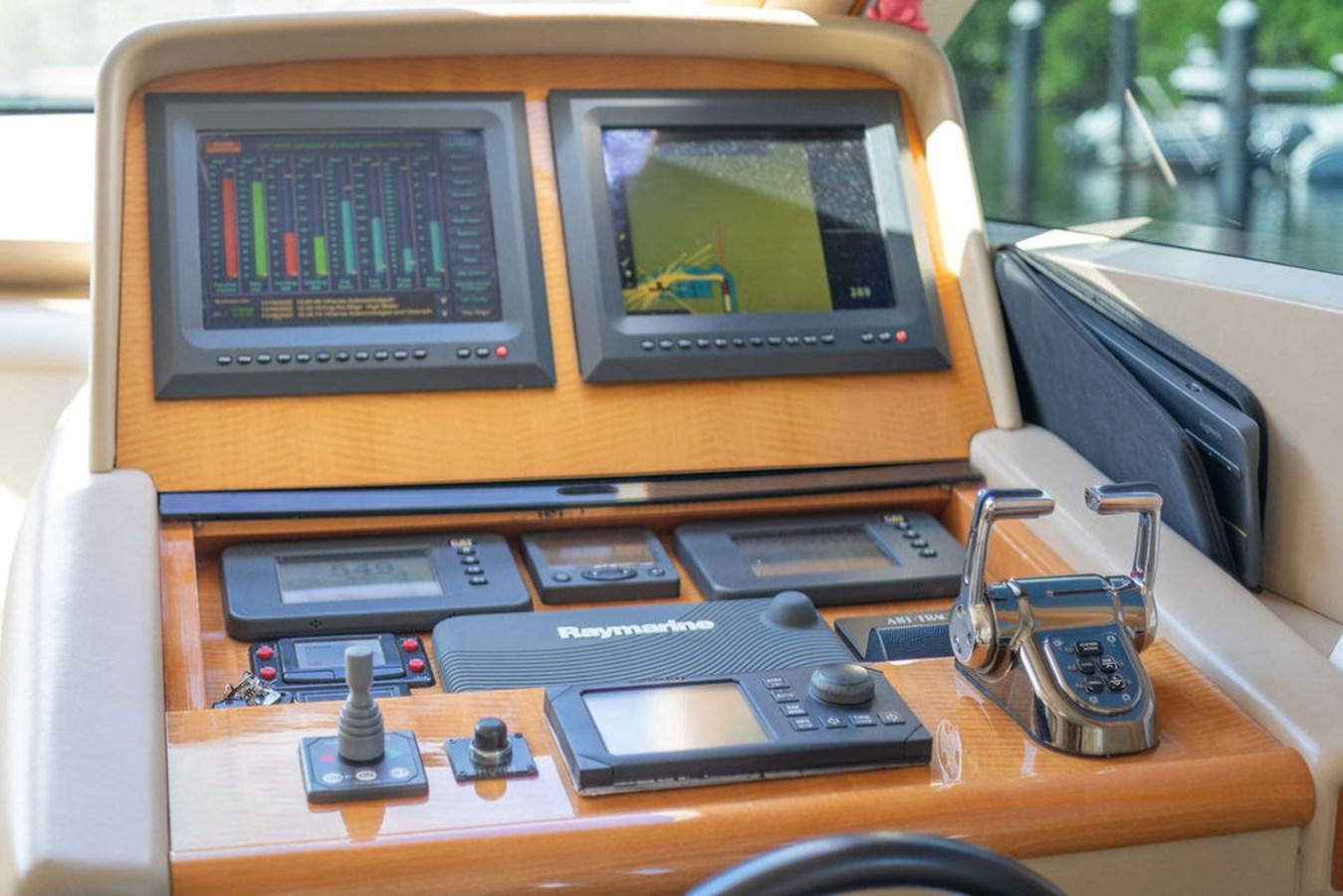 a desk with a computer and other electronics on it aboard CHIP Yacht for Sale