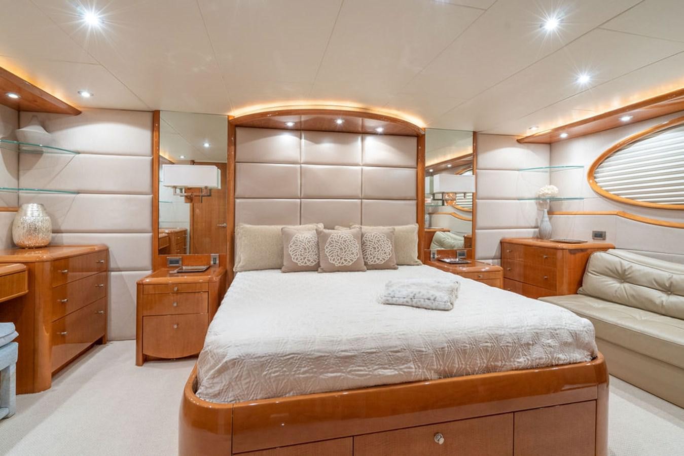 a bedroom with a bed and a mirror aboard CHIP Yacht for Sale
