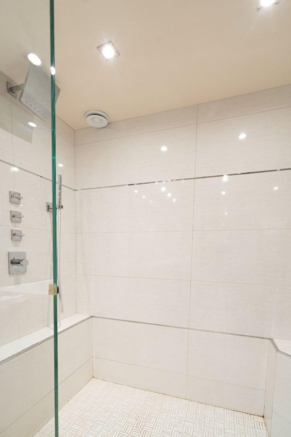 a shower unit with a glass door aboard CHIP Yacht for Sale
