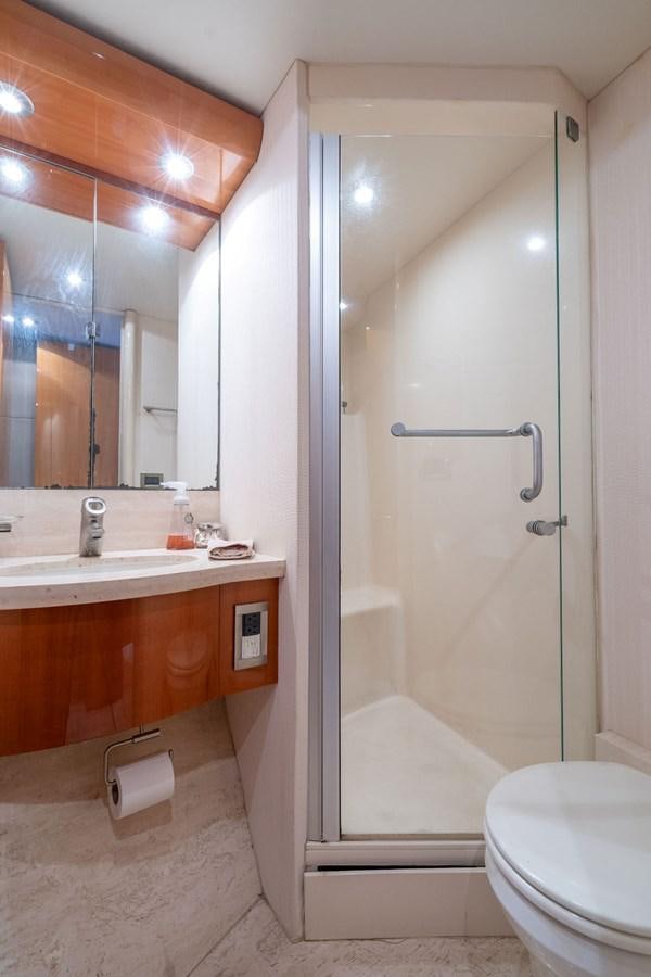 a bathroom with a glass shower aboard CHIP Yacht for Sale