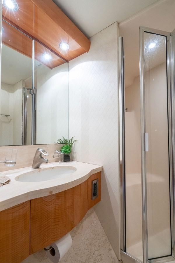 a bathroom with a glass shower aboard CHIP Yacht for Sale